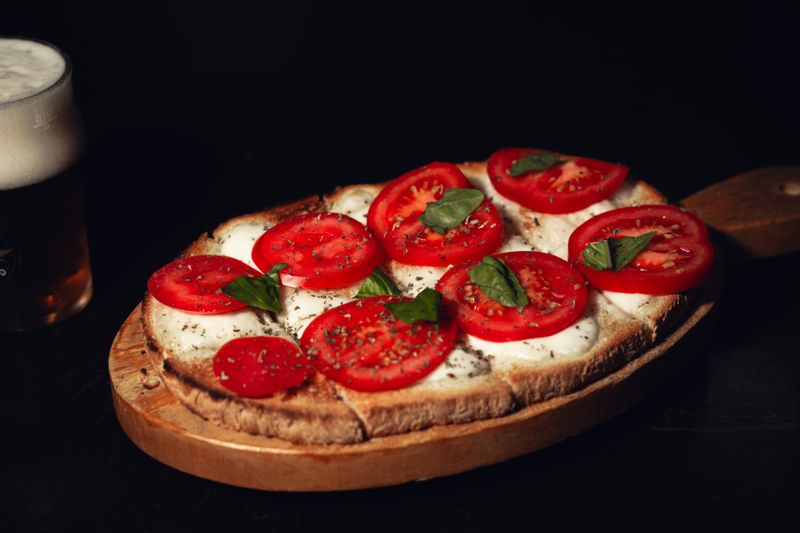 Burrata and Tomato bruschetta appetizer with fresh basil